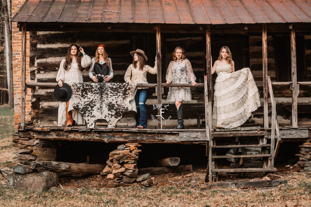 models at log cabin in western outfits