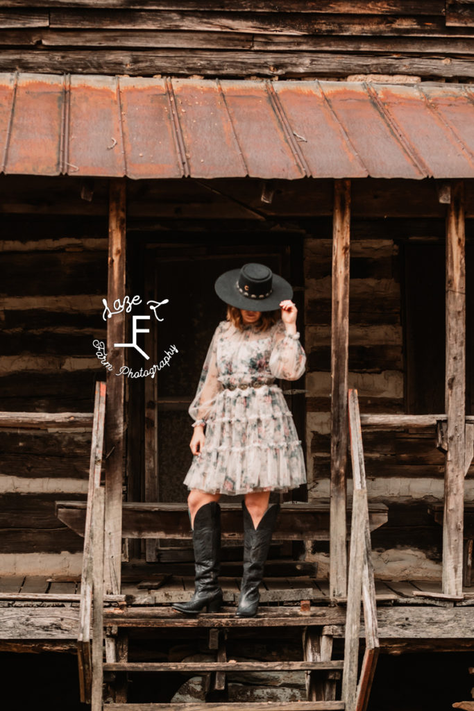 cowgirl in flower dress and tall black boots