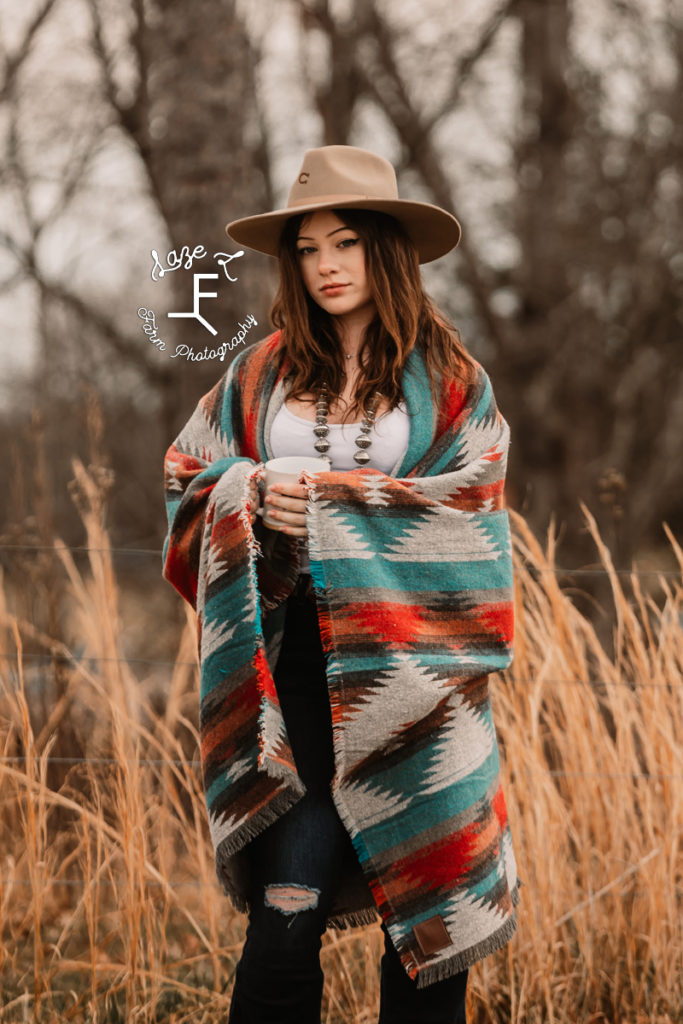 cowgirl in Pendleton blanket with coffee