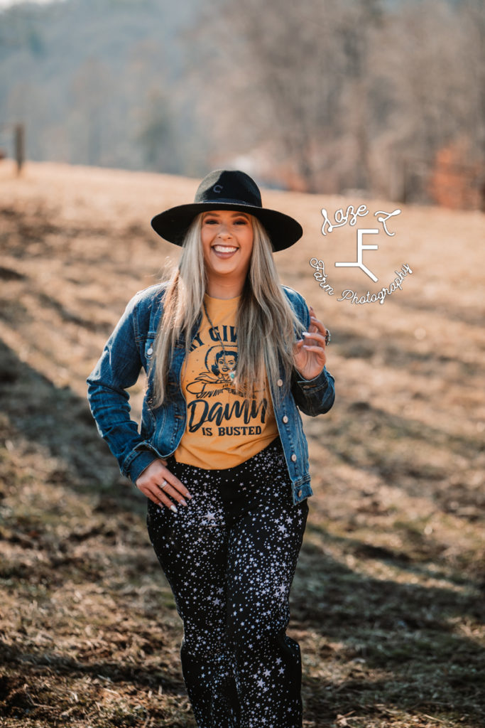 cowgirl in yellow shirt with black hat