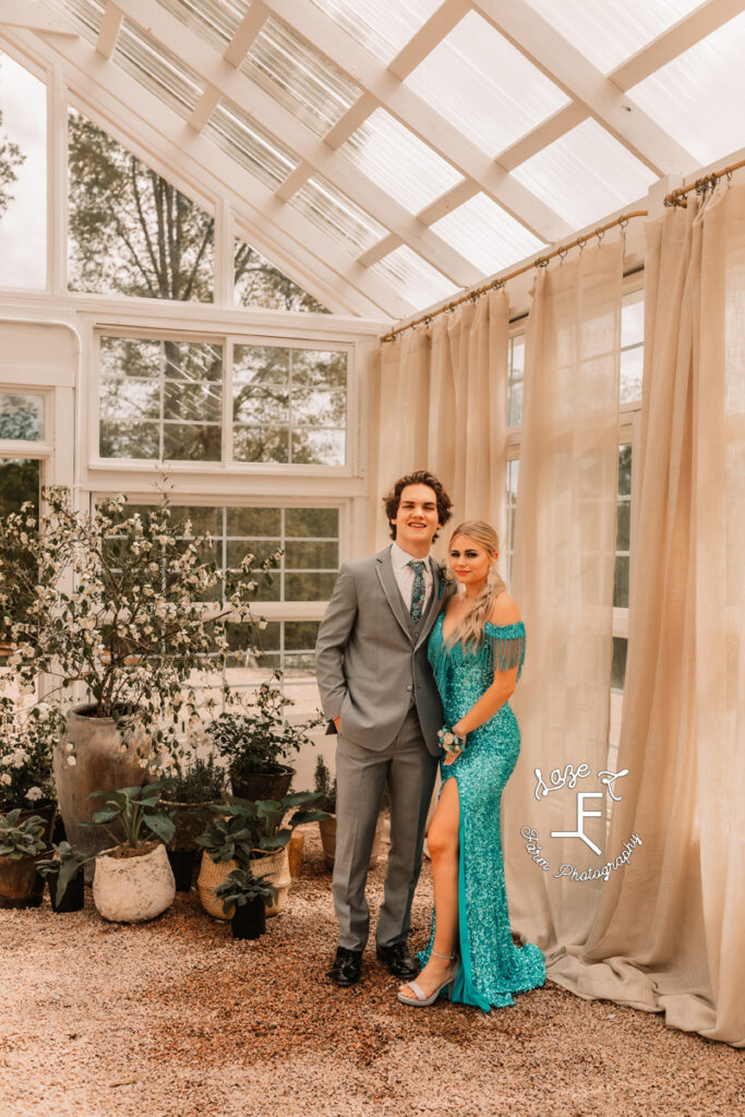 Reid and Tanner standing together in greenhouse