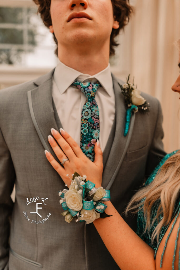 close up of corsage, tie and boutonniere