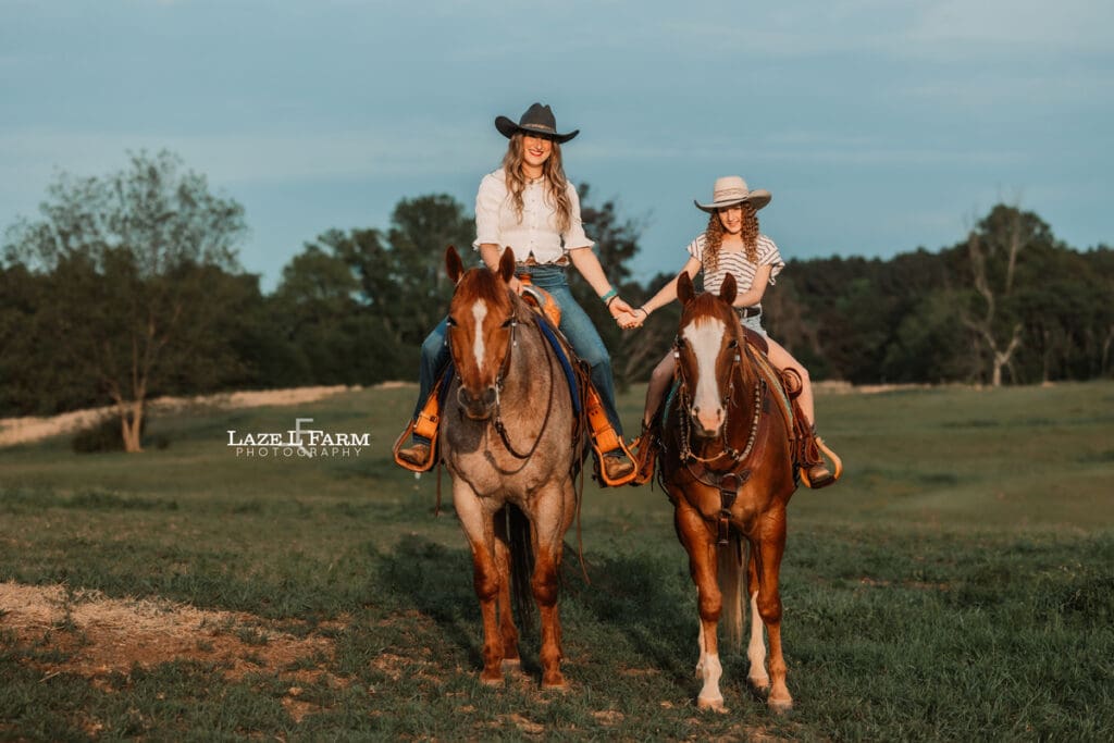 mom and daughter cowgirls sitting on their horses