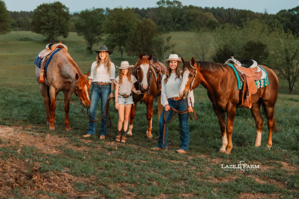 sister, mom and daughter cowgirls sitting on their horses