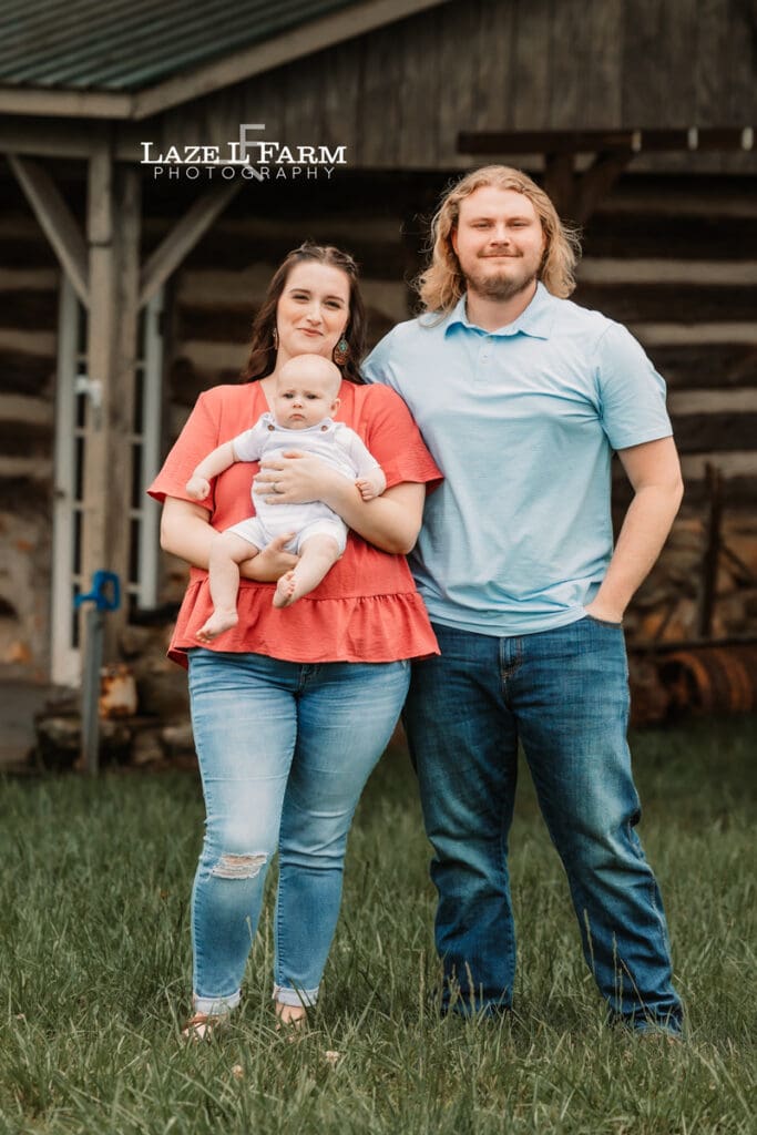 family standing in a field in the spring for family pictures