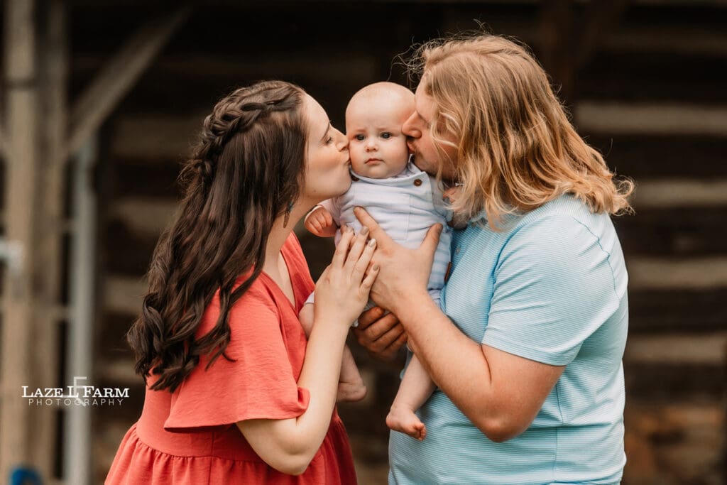 family kissing their baby for family pictures