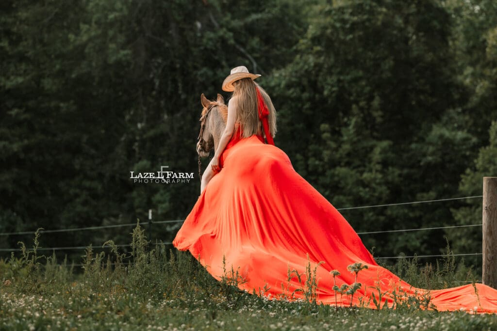cowgirl riding her horse in a parachute dress