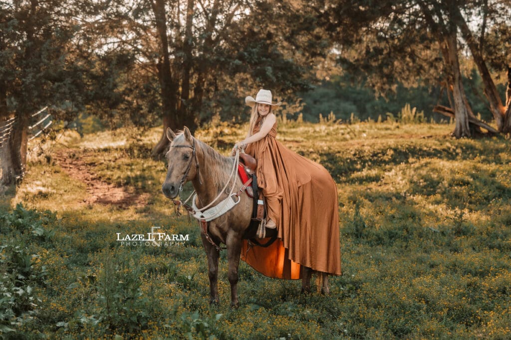 cowgirl riding her horse in a parachute dress