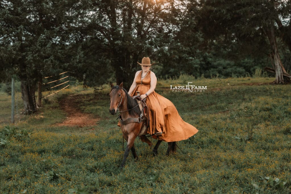 cowgirl riding her horse in a parachute dress