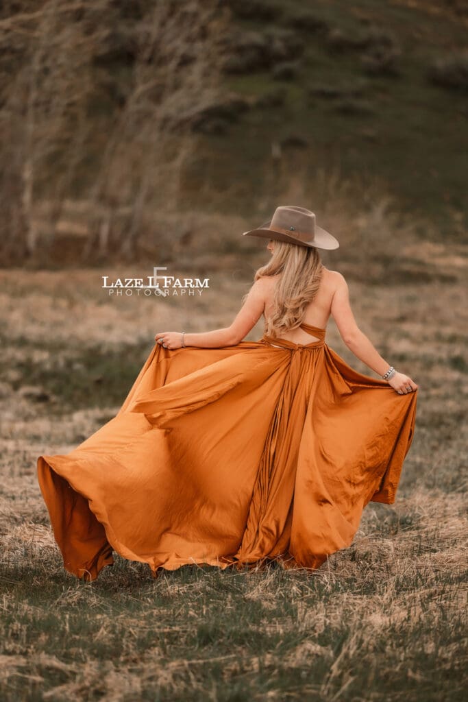 cowgirl in a copper dress and cowboy hat