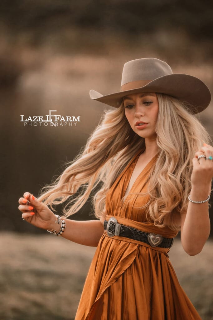 cowgirl wearing a copper dress and cowboy hat