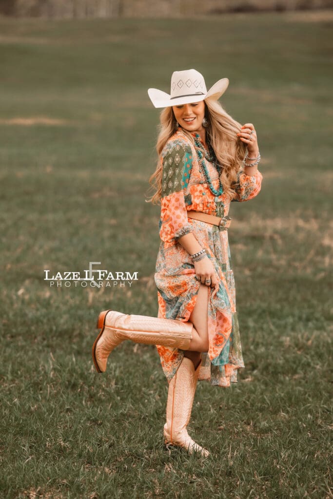 cowgirl showing off her cowgirl boots in her dress