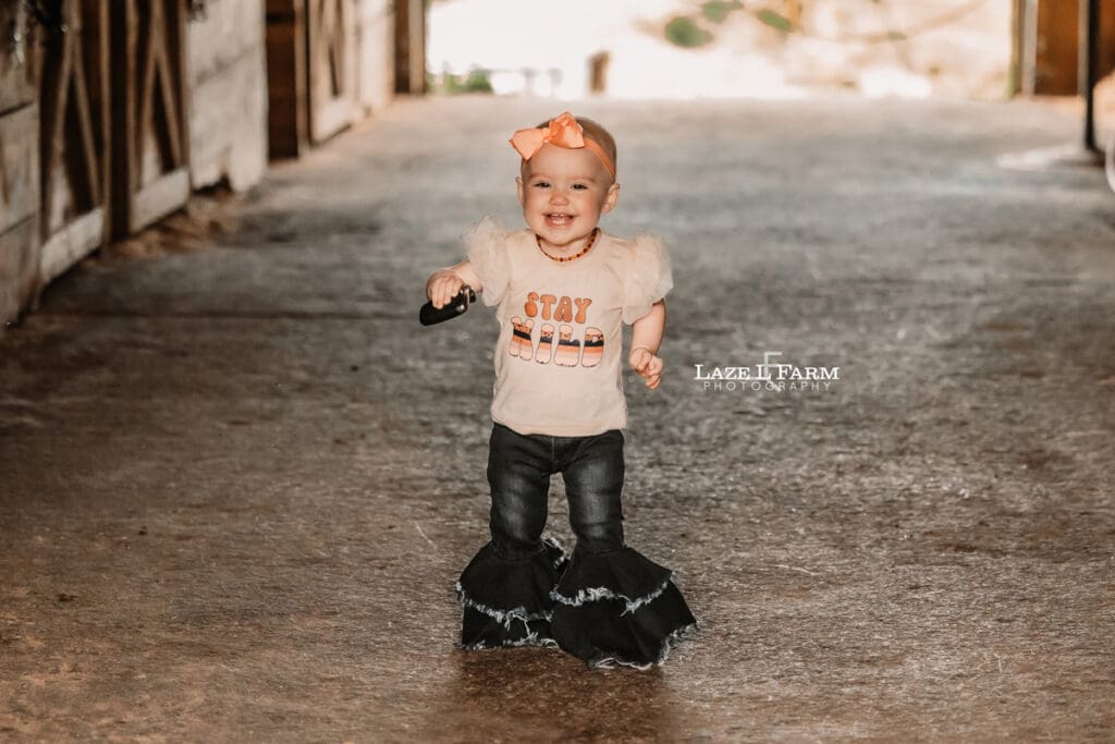 a little girl walking through the barn