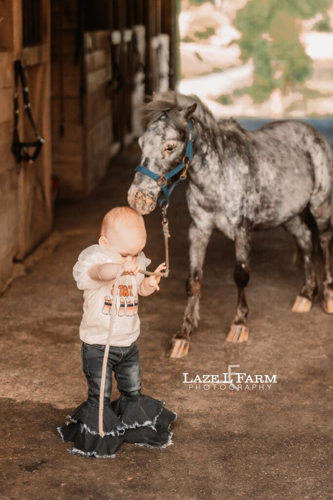 a little girl walking through the barn