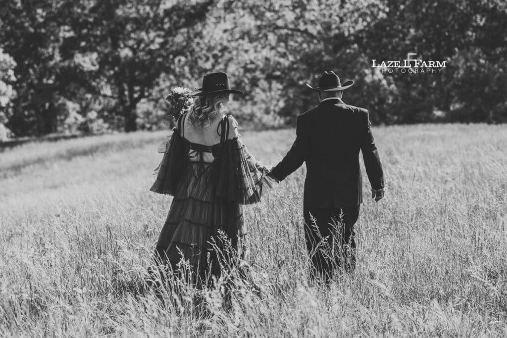 couple walking into the sunset up on top of the mountain for a photoshoot
