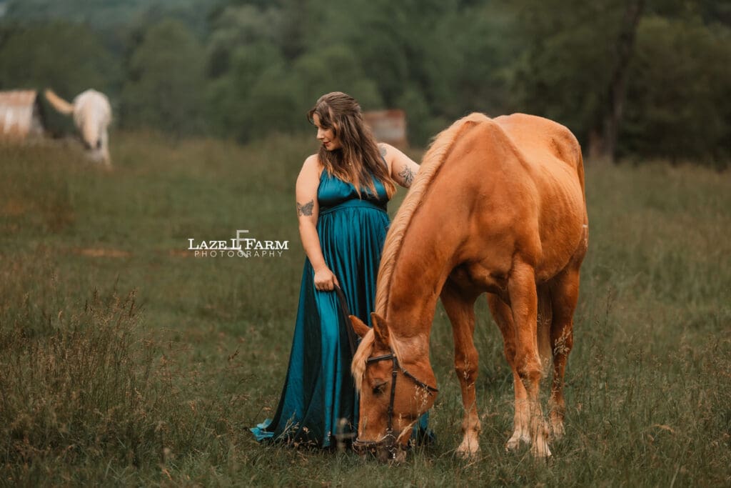 girl standing beside her horse in a field