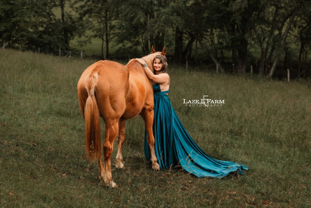 girl giving her horse a hug in a big flowy dress