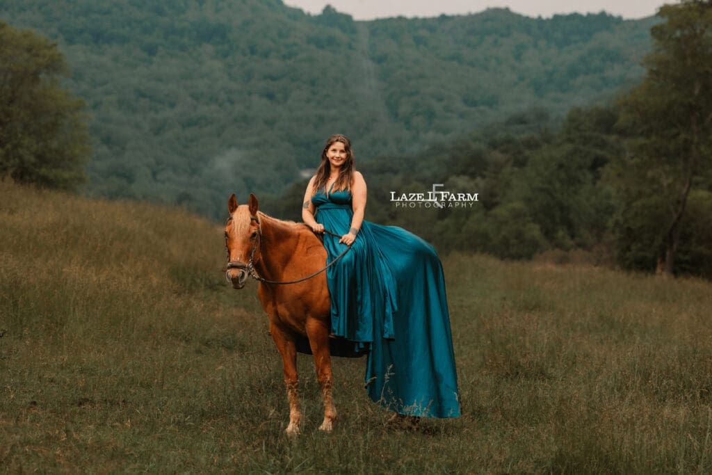 cowgirl riding her horse in a beautiful green dress