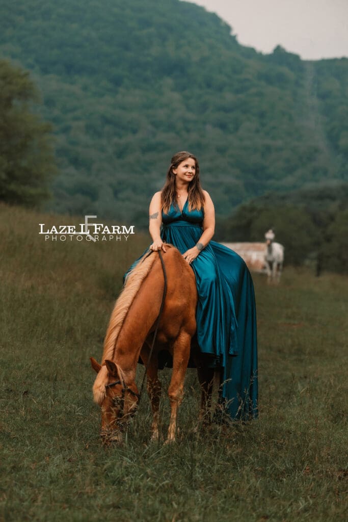 cowgirl riding her horse in a beautiful green dress