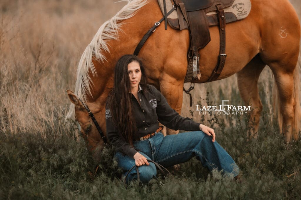 cowgirl and her palomino horse in a field