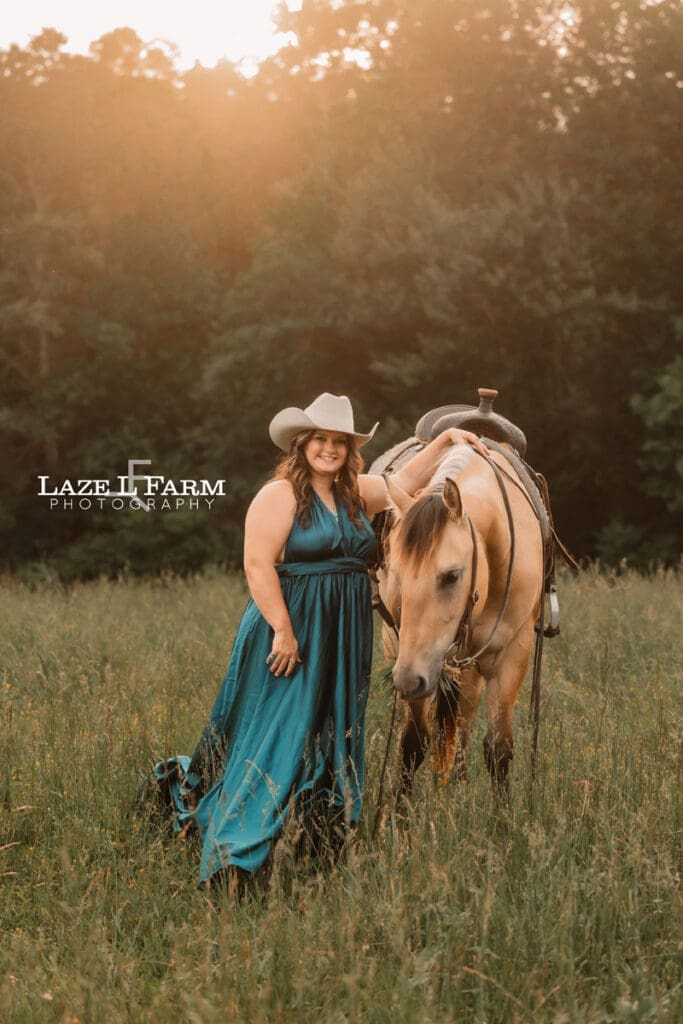 cowgirl in a turquoise parachute dress with her horse