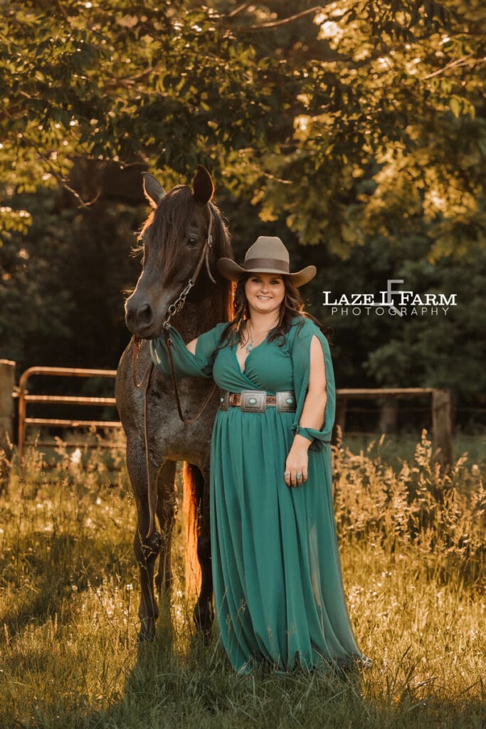 cowgirl in a dress with her blue roan horse