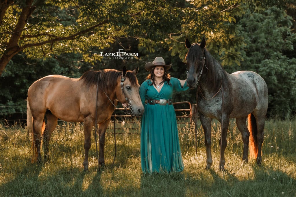 cowgirl in a dress with her two horses