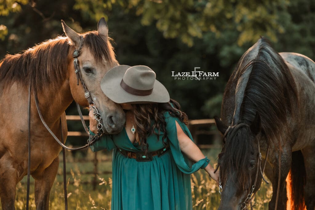 cowgirl kissing her horse on the nose