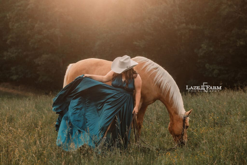 cowgirl in a turquoise parachute dress with her horse