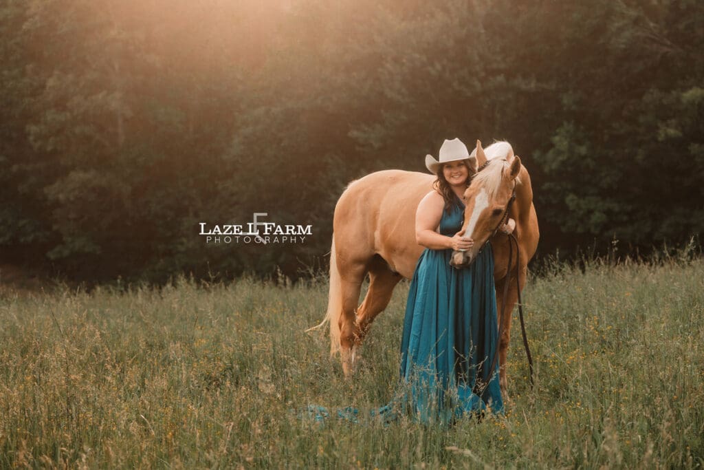 cowgirl in a turquoise parachute dress with her horse