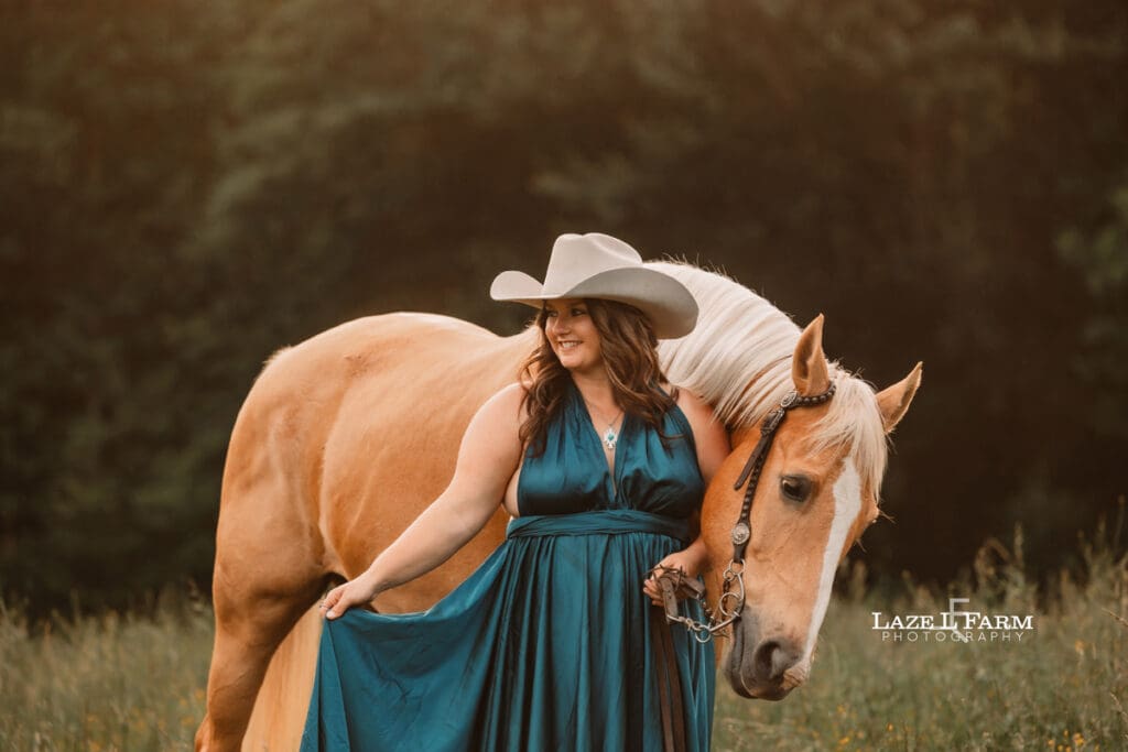 cowgirl in a turquoise parachute dress with her horse