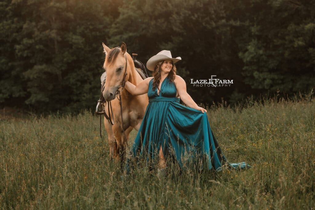 cowgirl in a turquoise parachute dress with her horse