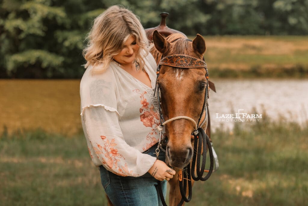 cowgirl giving her horse a hug