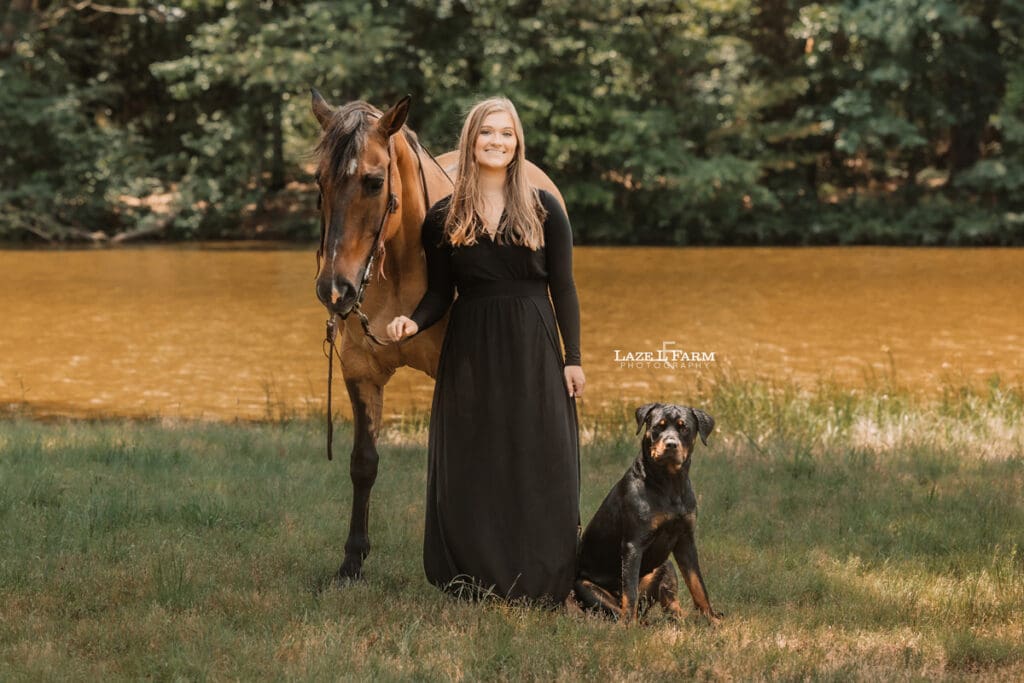 cowgirl with her horse and dog