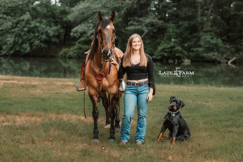 cowgirl with her horse and her dog