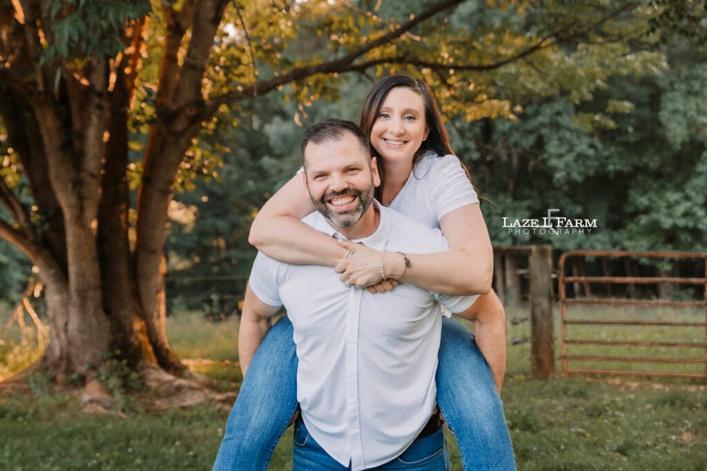 couple piggy back looking at the camera