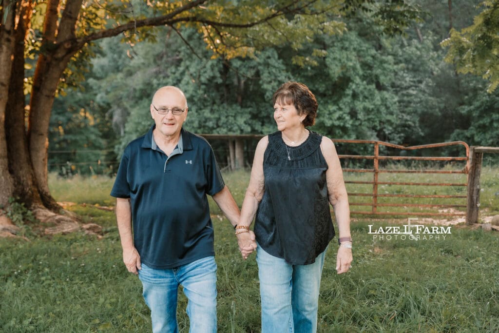 couple holding hands walking towards the camera