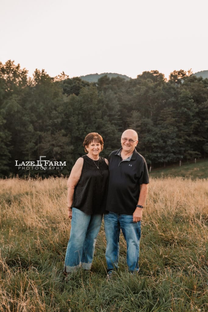 couple out in a field at sunset