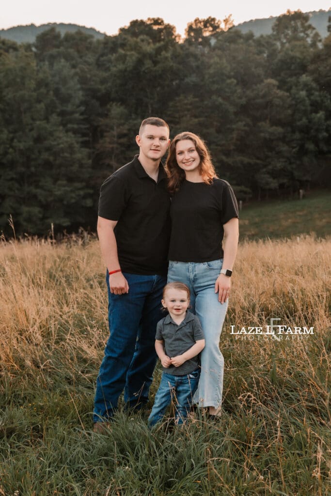 family out in a field at sunset