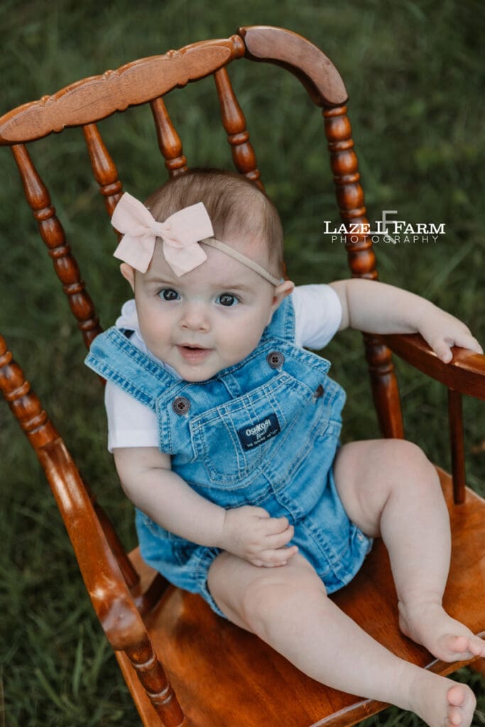 little girl in a rocking chair looking at the camera