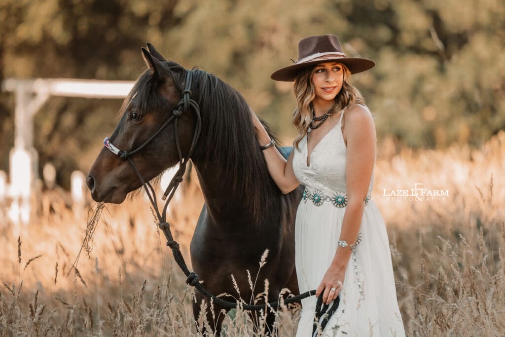 cowgirl with her horse looking away from the camera