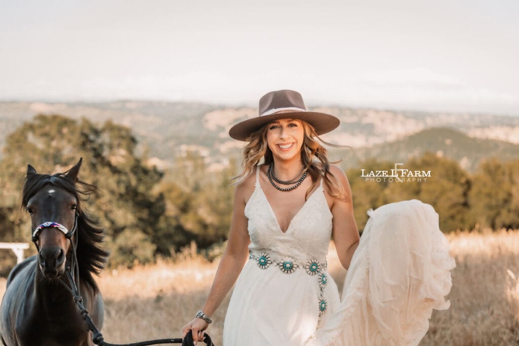 cowgirl in a dress looking at the camera