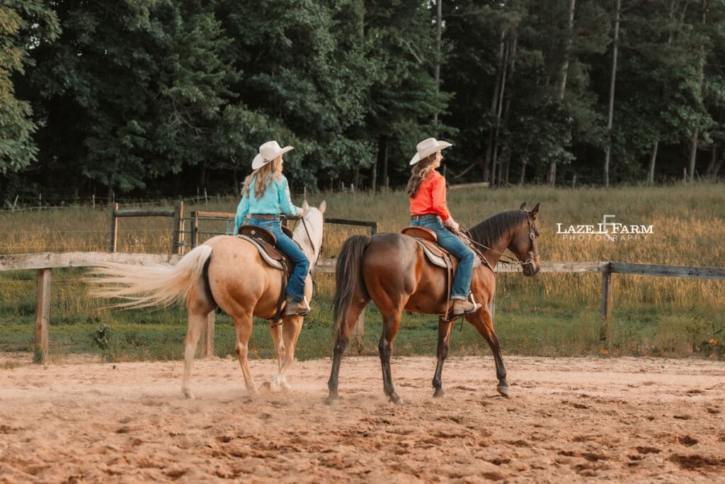 best friend cowgirls riding their horses in the arena