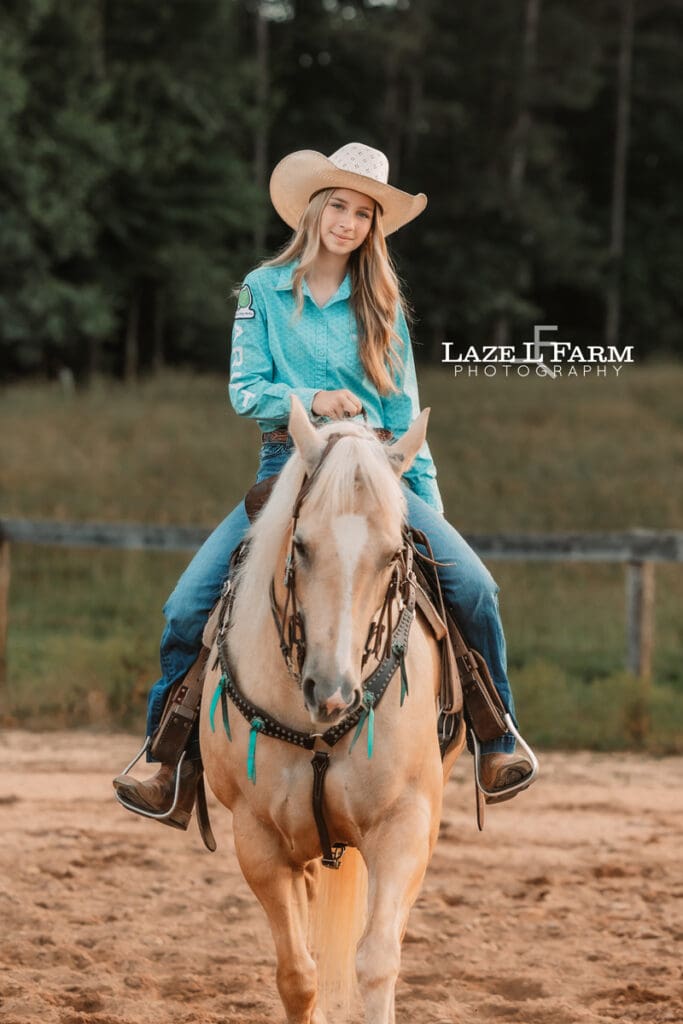 cowgirl on her horse looking at the camera