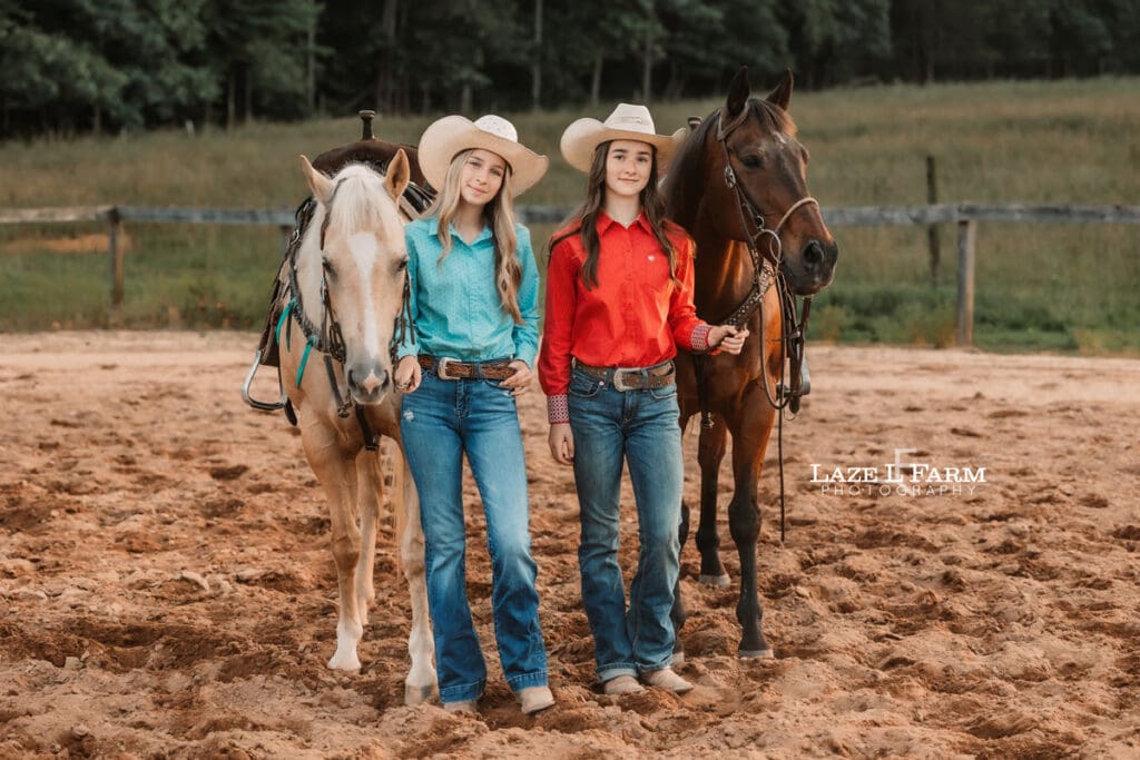 best friend cowgirls holding their horses