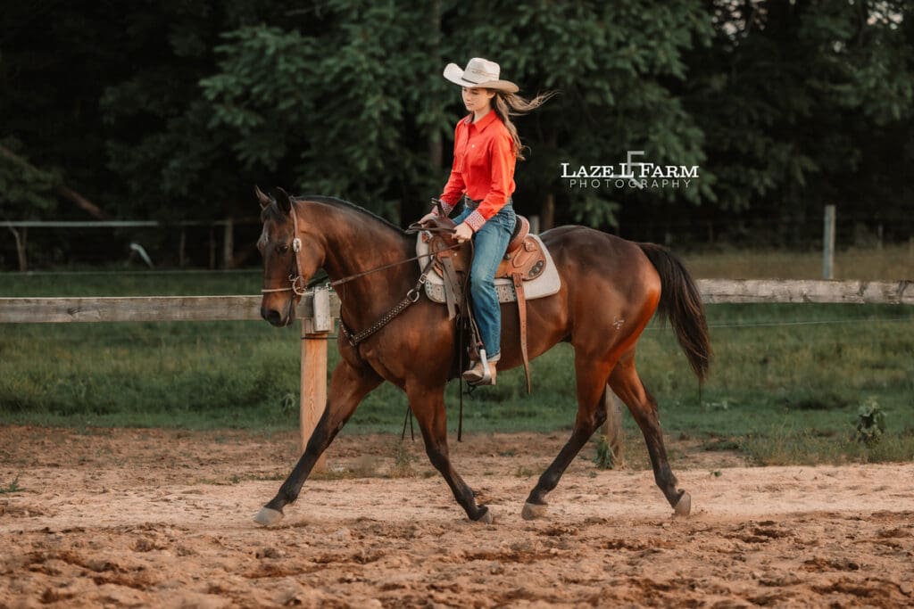 cowgirl trotting her horse