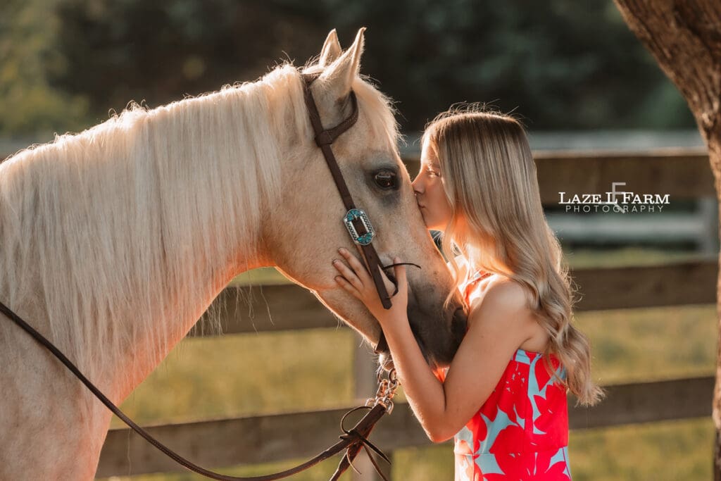 girl kissing her horse