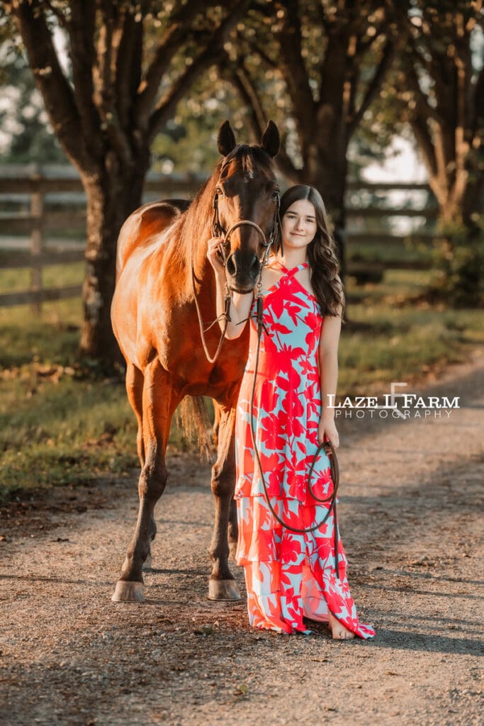 girl standing beside of her horse