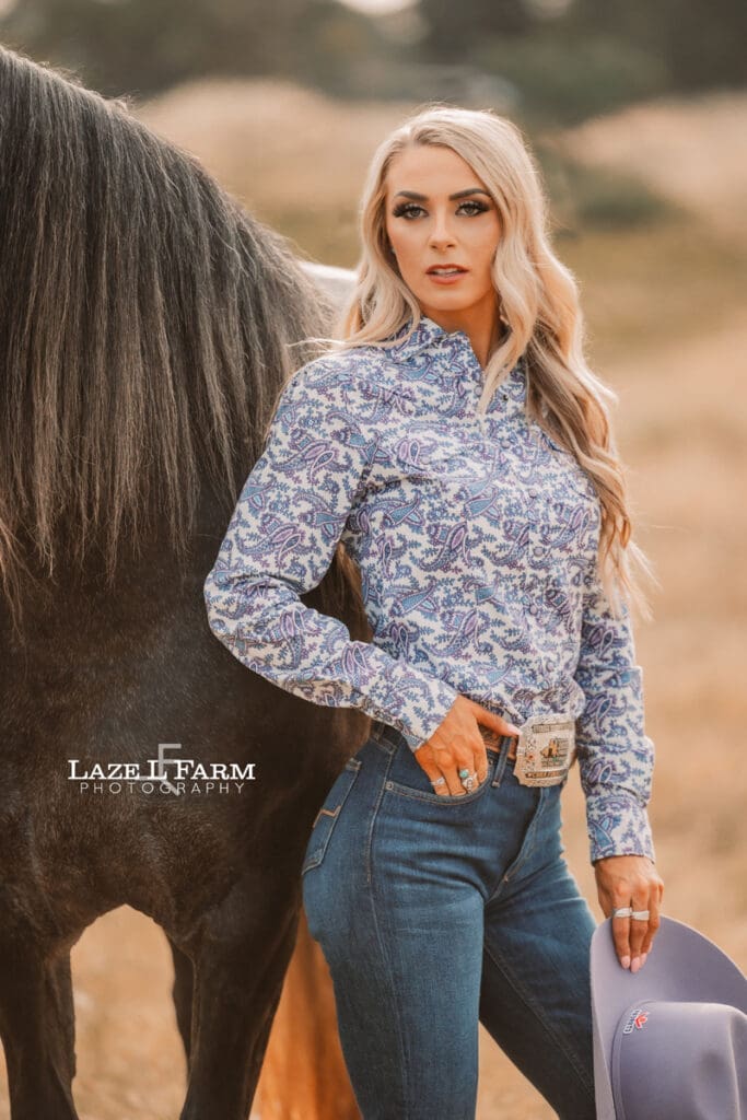 cowgirl and her horse standing in a field