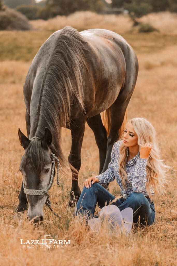 cowgirl and her horse standing in a field